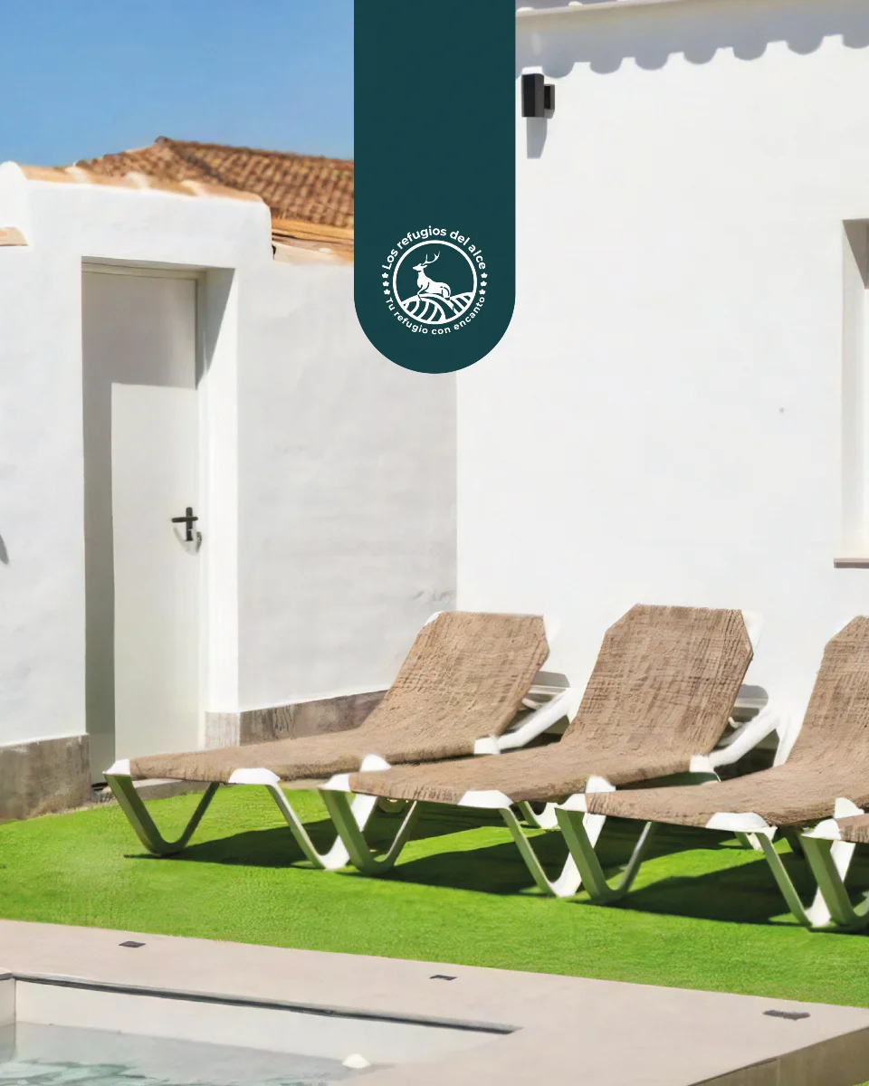 Sun loungers on the lawn beside the property's private pool