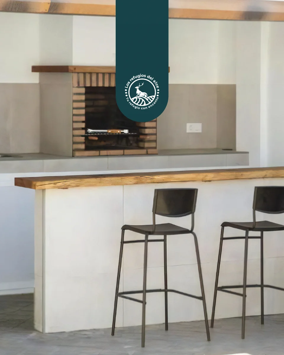 Wooden bar and stools beside the villa's barbecue