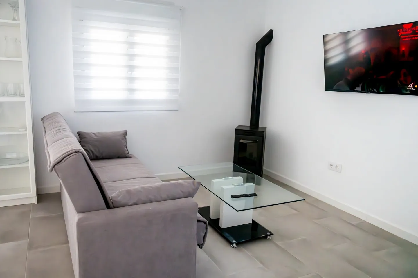 Living room of Casa Dafer with sofa, television and a modern stove
