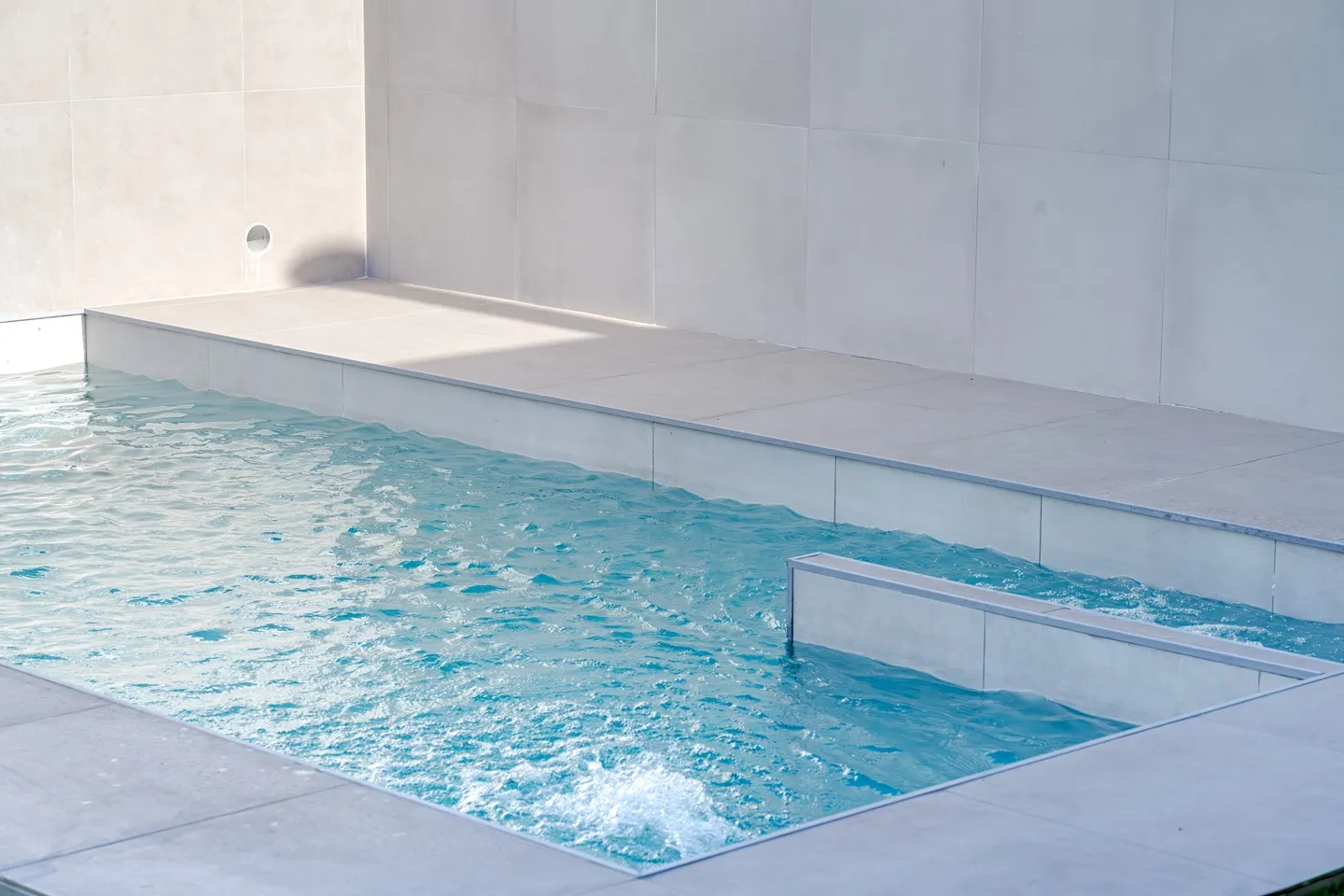 Detail of the corner pool at Casa Joal with turquoise water and light-toned walls