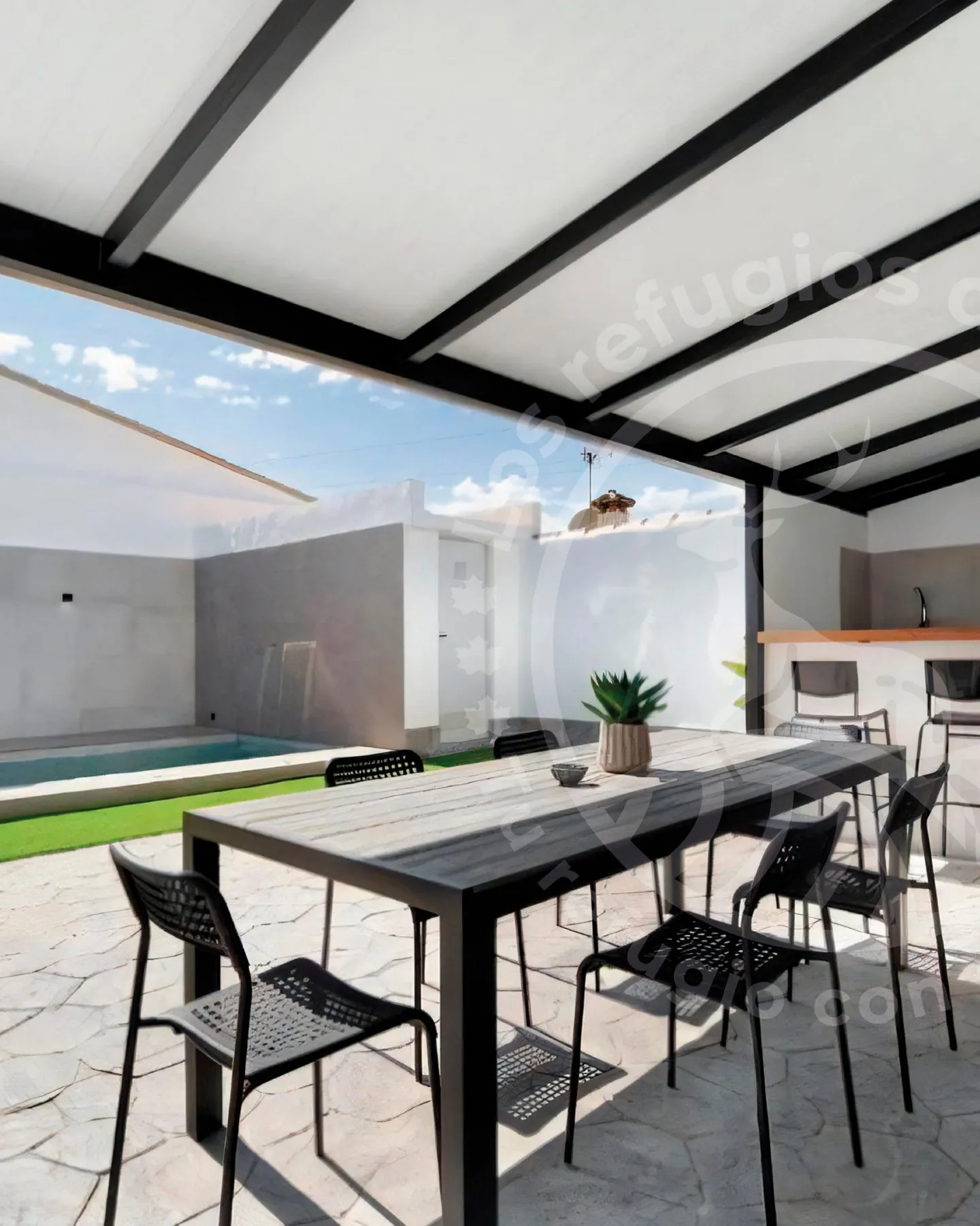 Covered barbecue porch, outdoor dining table and pool in the background in Chiclana